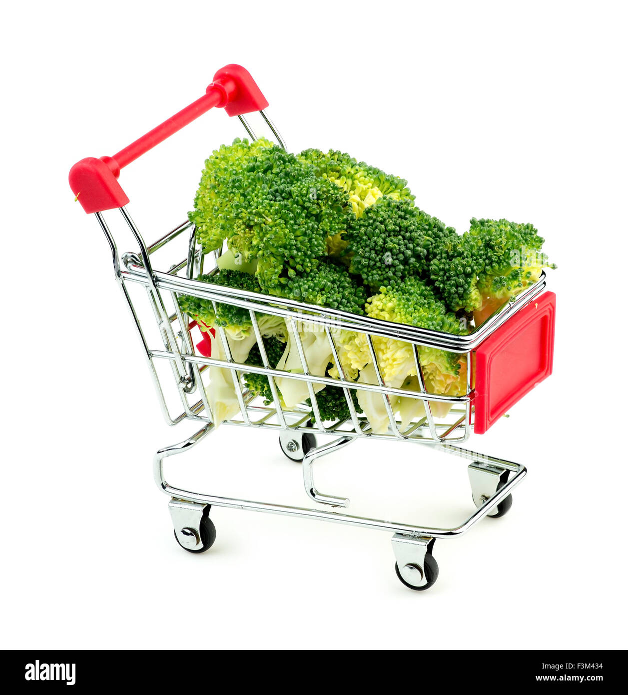 Studio shot of freshly cut green broccoli in mini shopping trolley Stock Photo