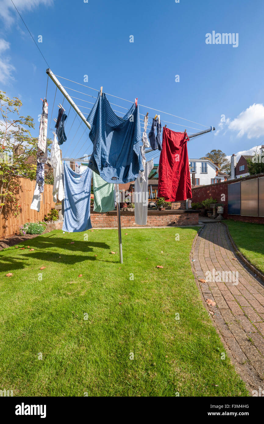 Washing on a rotory cloths line in a back garden. Stock Photo