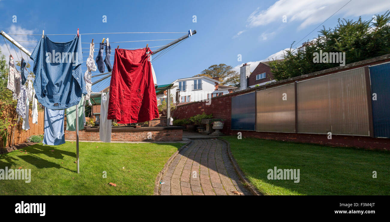 Washing on a rotory cloths line in a back garden. Stock Photo