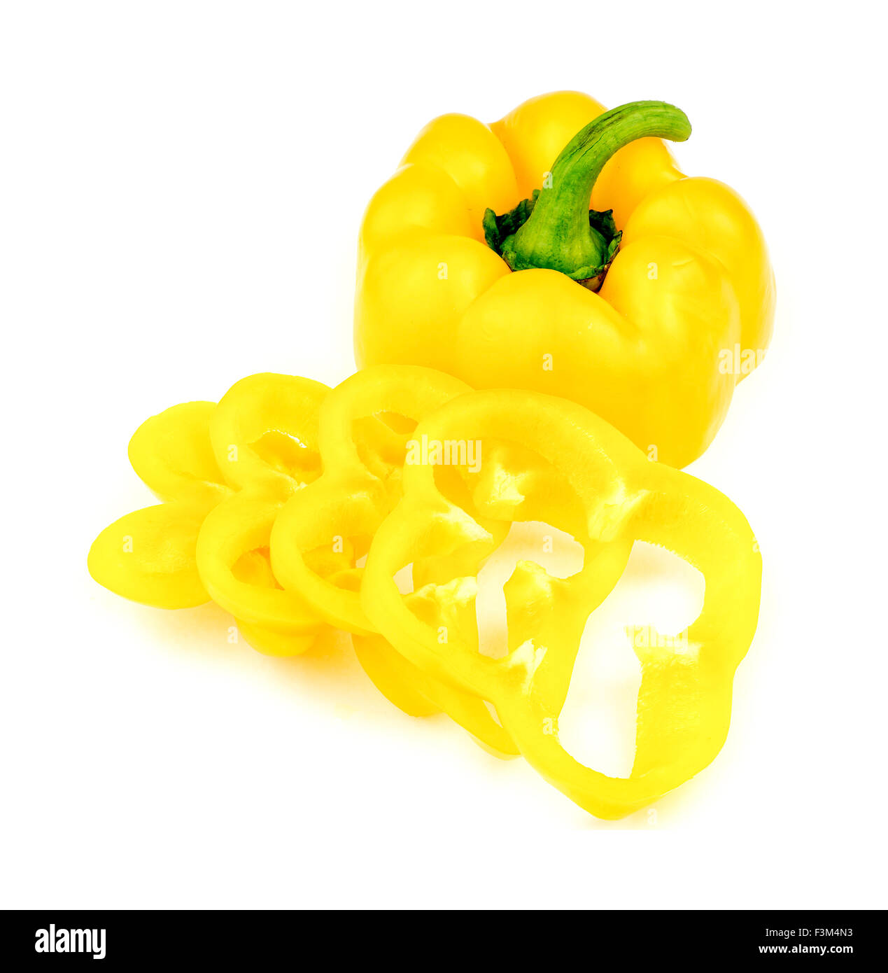 Whole yellow capsicum pepper with sliced cross sections Stock Photo