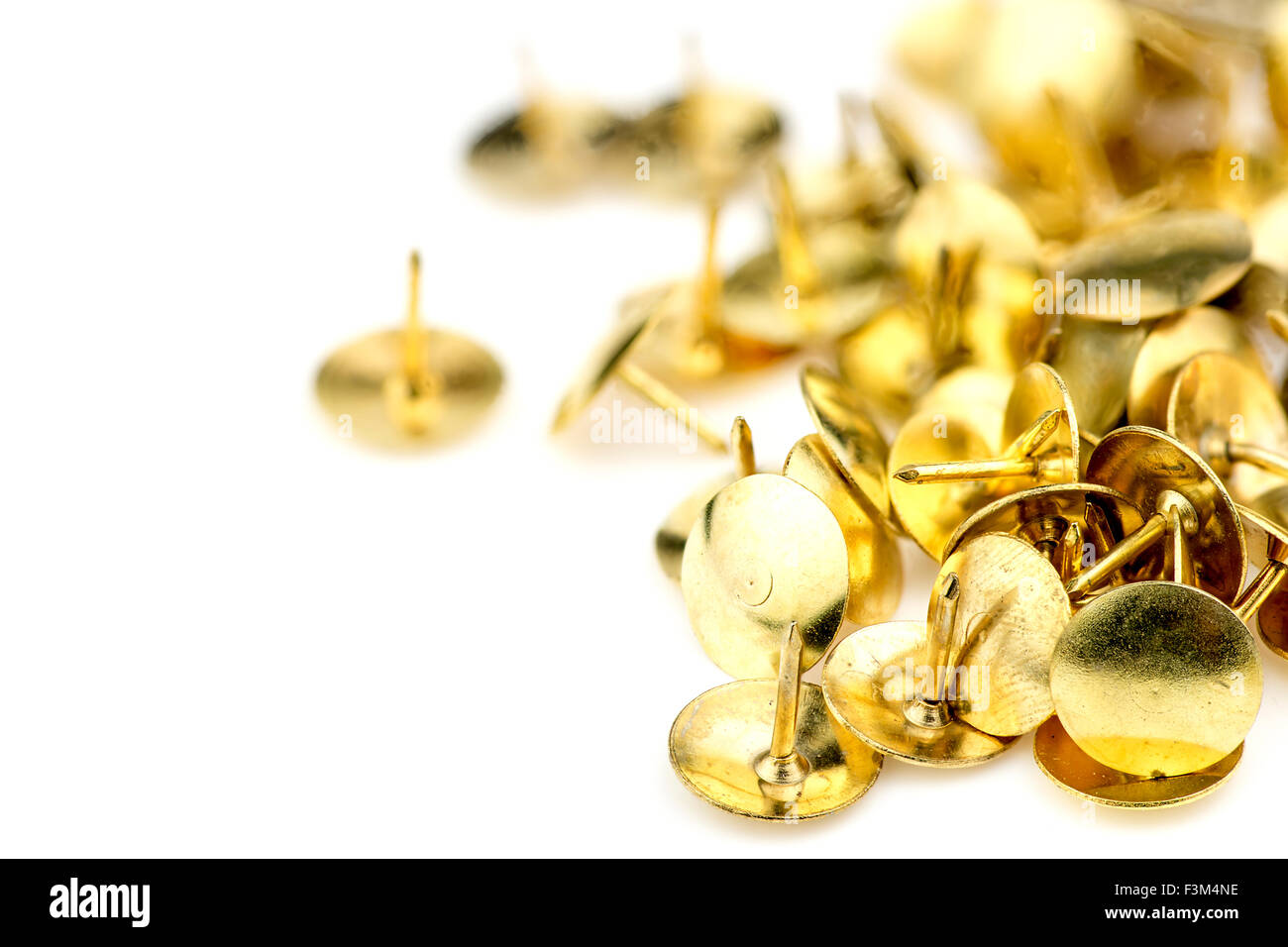 Macro of golden thumb tacks background Stock Photo Alamy