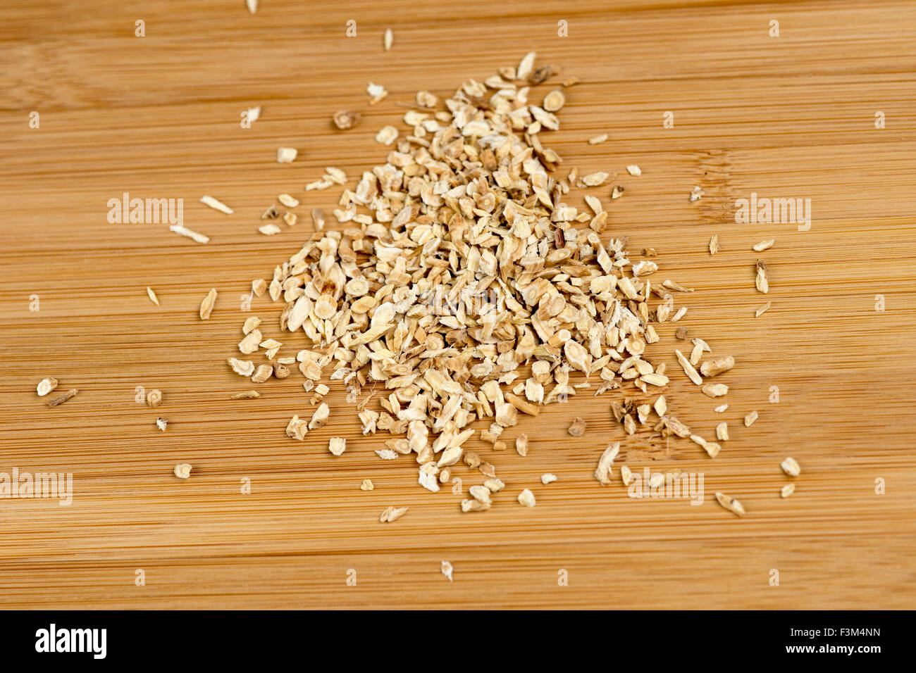 Astragalus membranaceus against a wooden board Stock Photo