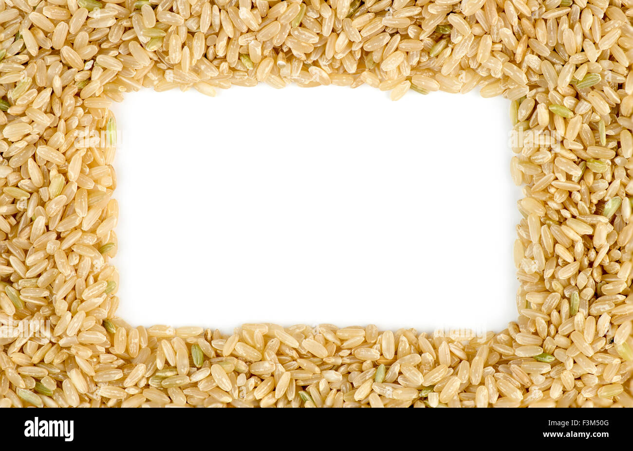 White copyspace surrounded by macro of whole brown rice grains Stock Photo