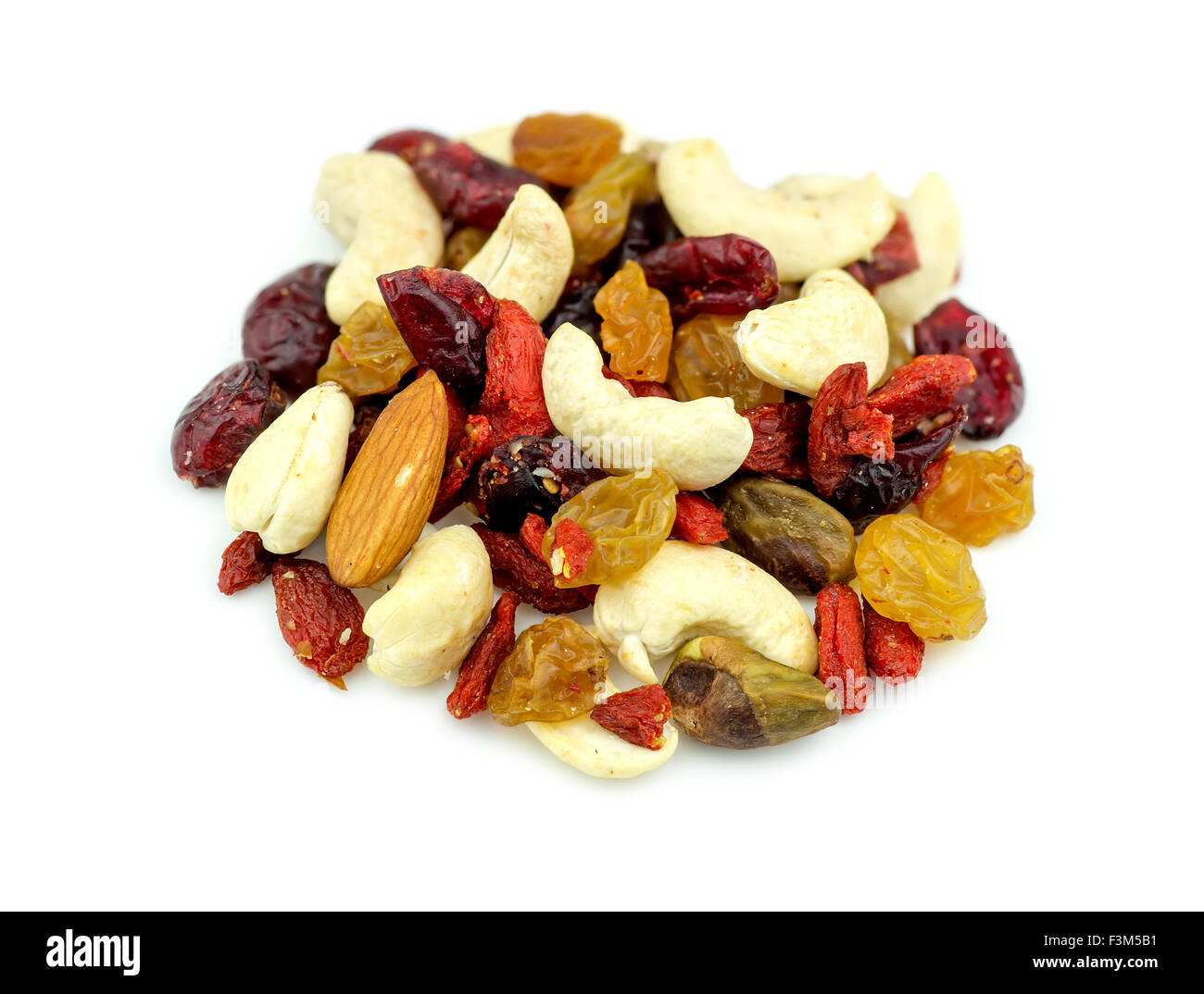 Macro closeup of mixed nuts and dried fruits isolated on white Stock Photo