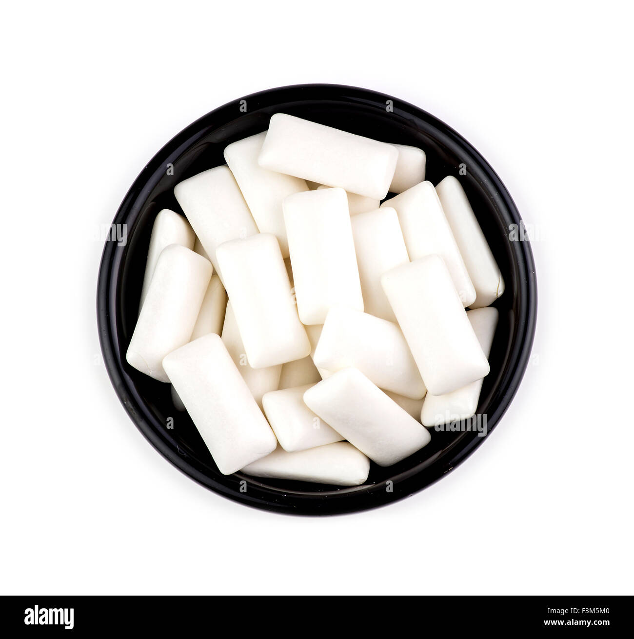 Bowl with pieces of tasty white chewing gum Stock Photo