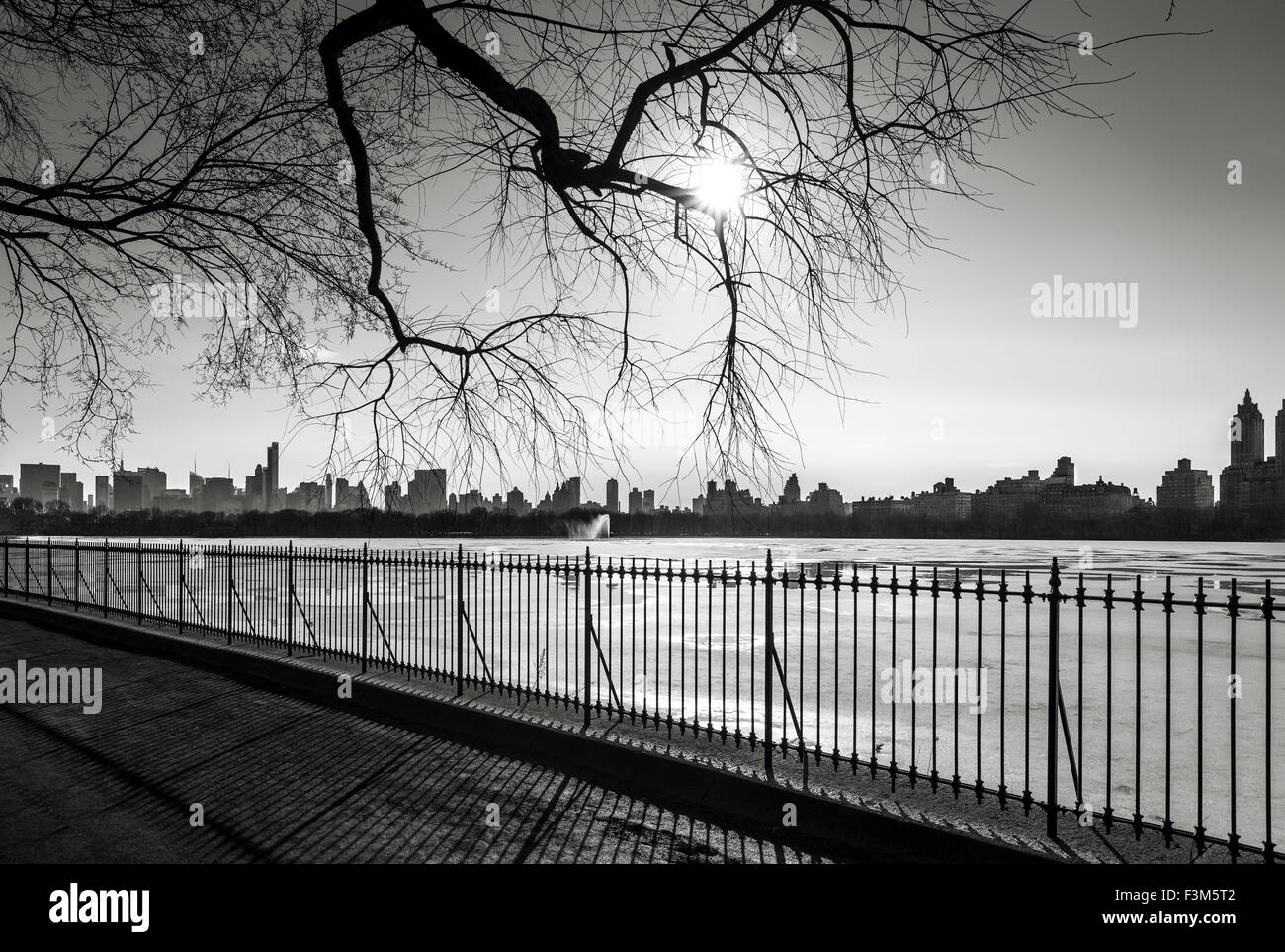 Black and White photograph of New York in winter, The Reservoir in Central Park and Upper West Side, NYC. Stock Photo