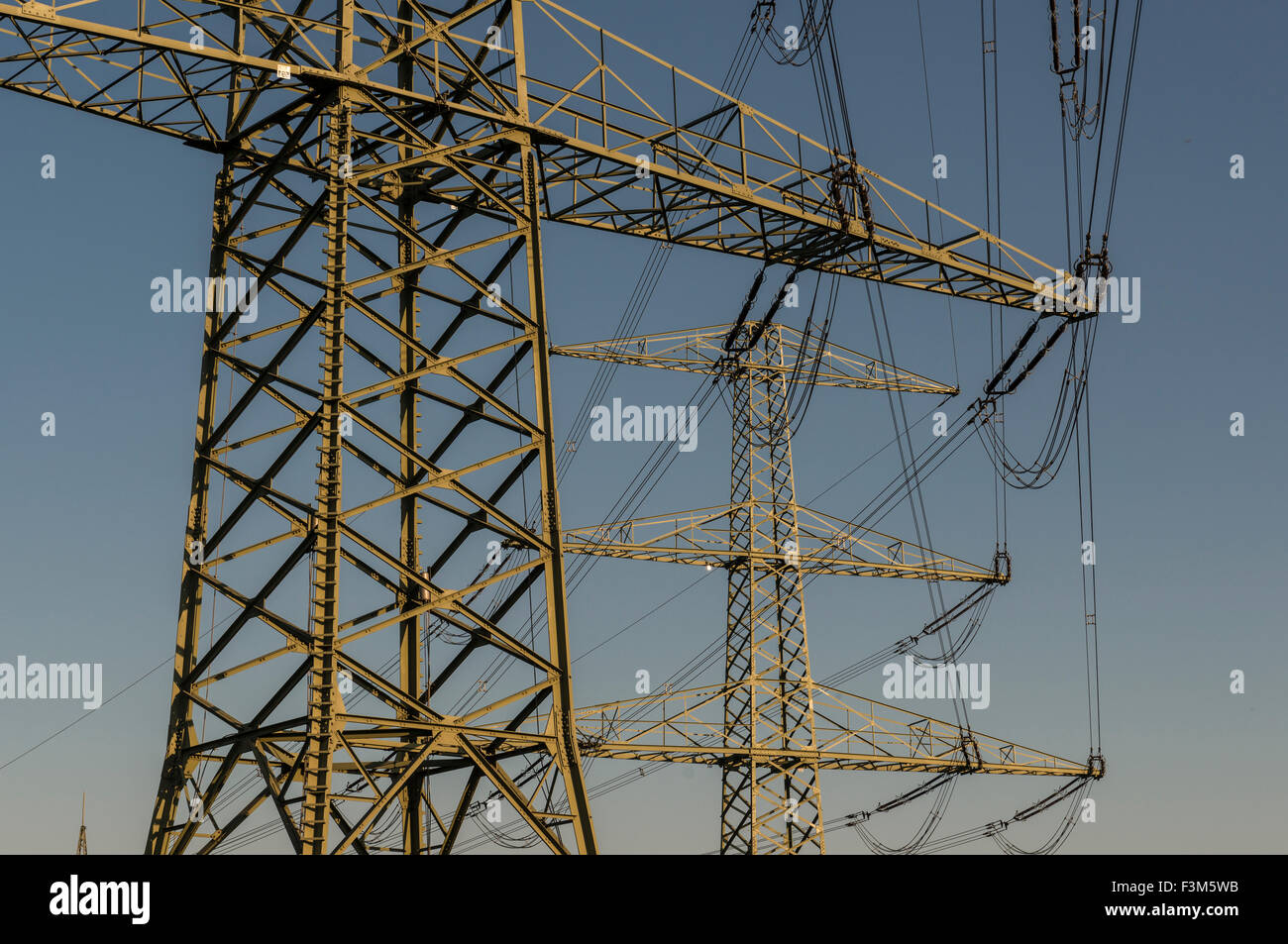 Overhead powerline in front of blue sky Stock Photo