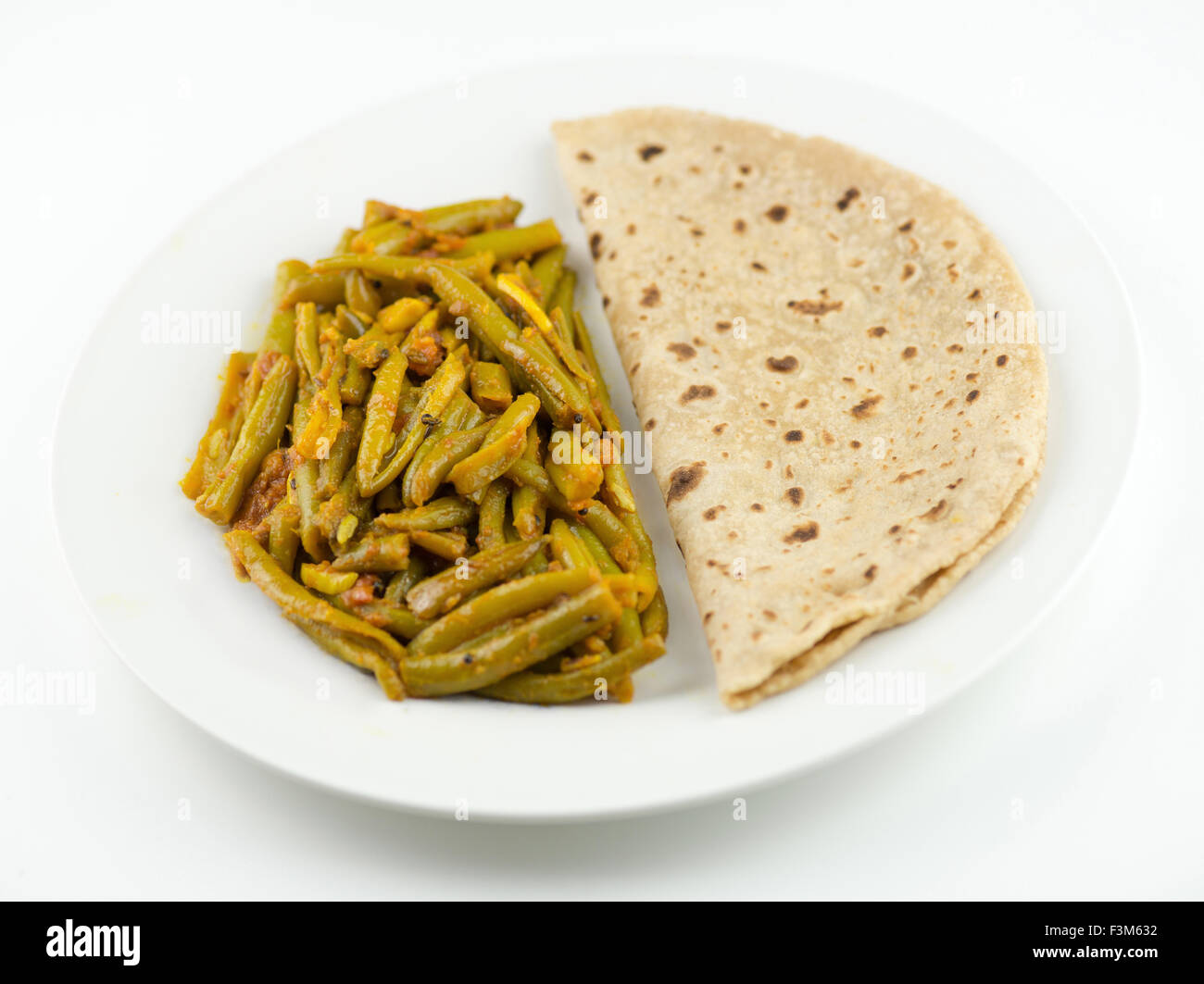 Simple and traditional Indian meal with roti and breen bean curry Stock Photo