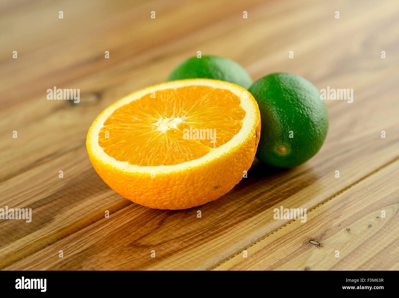 Sliced orange with deep green limes Stock Photo