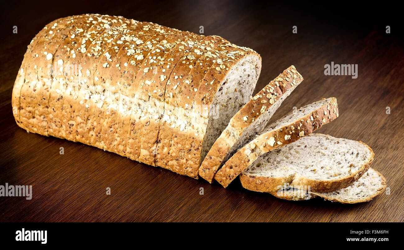 Fresh whole wheat bread against wooden background Stock Photo