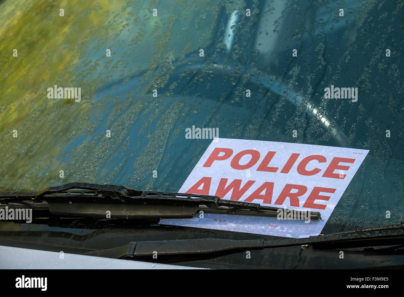 Police Aware sign on the windscreen of an abandoned car Stock Photo