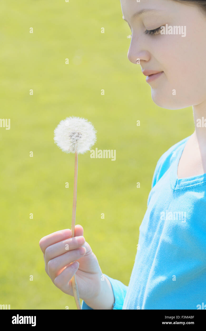 Field,Dandelion,Teenage Girl,Holding,Smiling Stock Photo