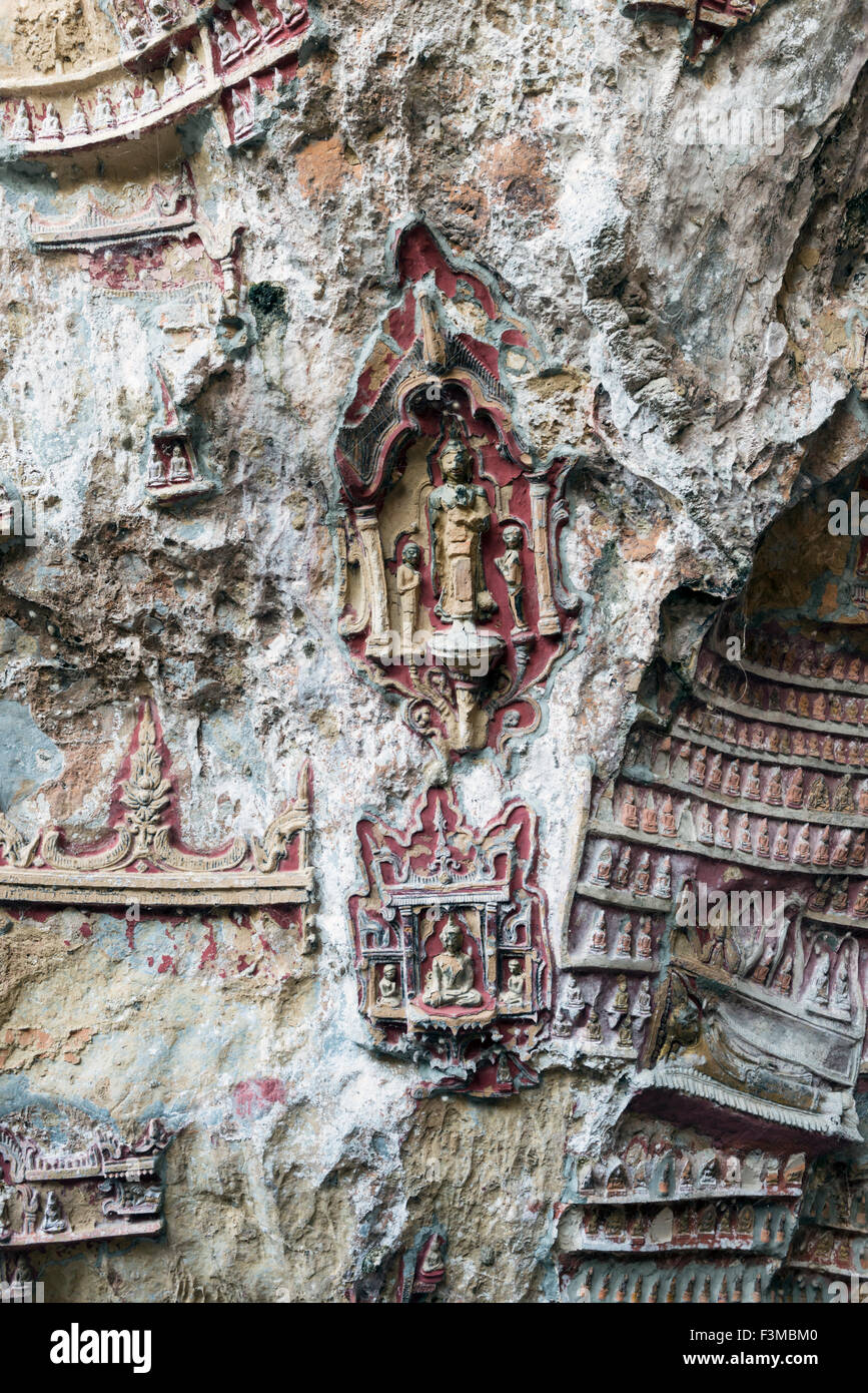 Religious symbols carved on cave wall, Burma Stock Photo