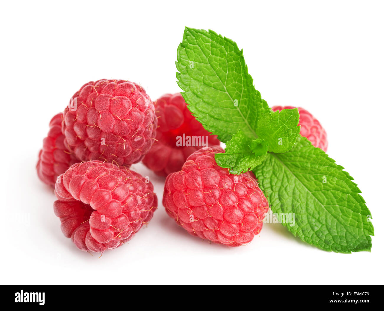 fresh ripe raspberries with mint leaves isolated on white Stock Photo