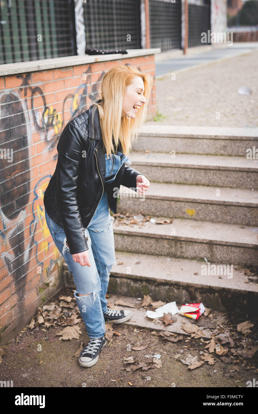 young beautiful blonde straight hair woman wearing jeans overalls