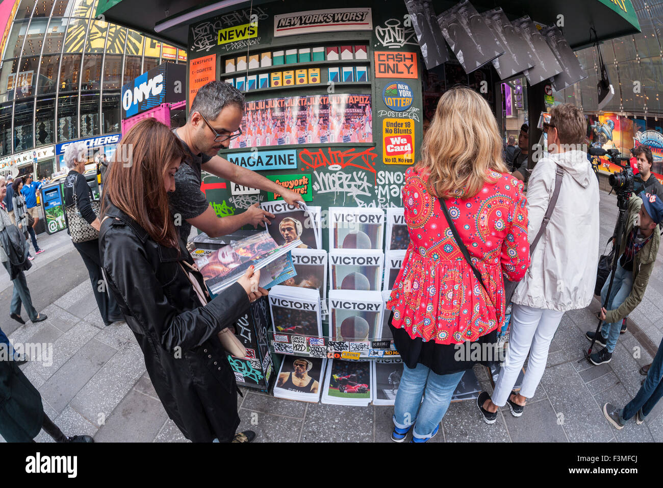 New York, NY, USA. 09th Oct, 2015. Customers browse magazines at 'T. SQ Newsstand' in Times Square in New York on Friday, October 9, 2015. Created by the artist Kimou 'Grotesk' Meyer with Victory Journal and Juxtapoz Magazine, the pop-up displays and sells art and culture zines created by a litany of artists. It will be in business at the crossroads of the world until October 18. Credit:  Richard Levine/Alamy Live News Stock Photo