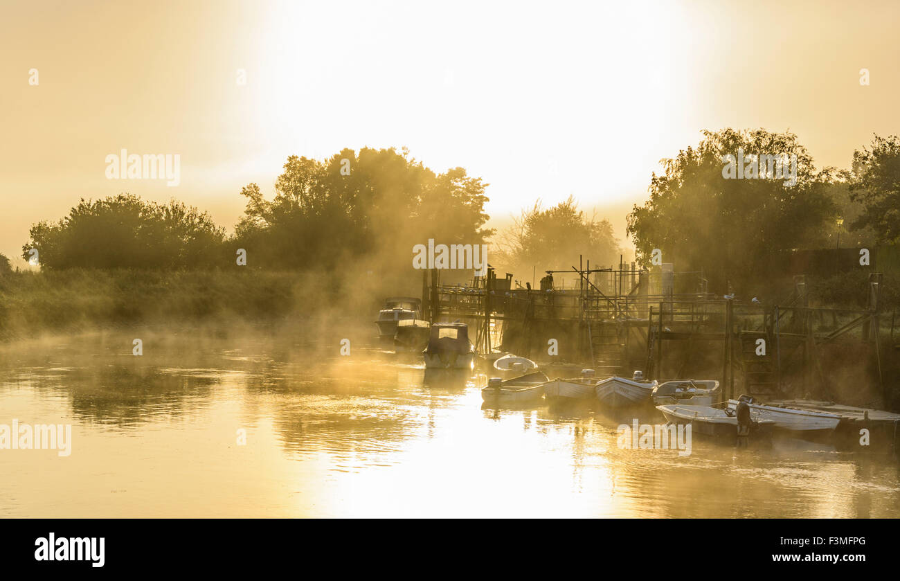 Evaporating steam fog rising over the River Arun on a cold morning in Arundel, West Sussex, England, UK. Stock Photo