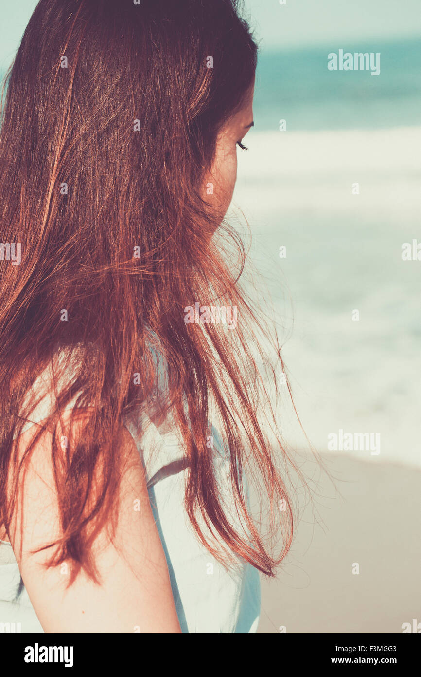 Historical young woman on the beach wearing a blue dress Stock Photo