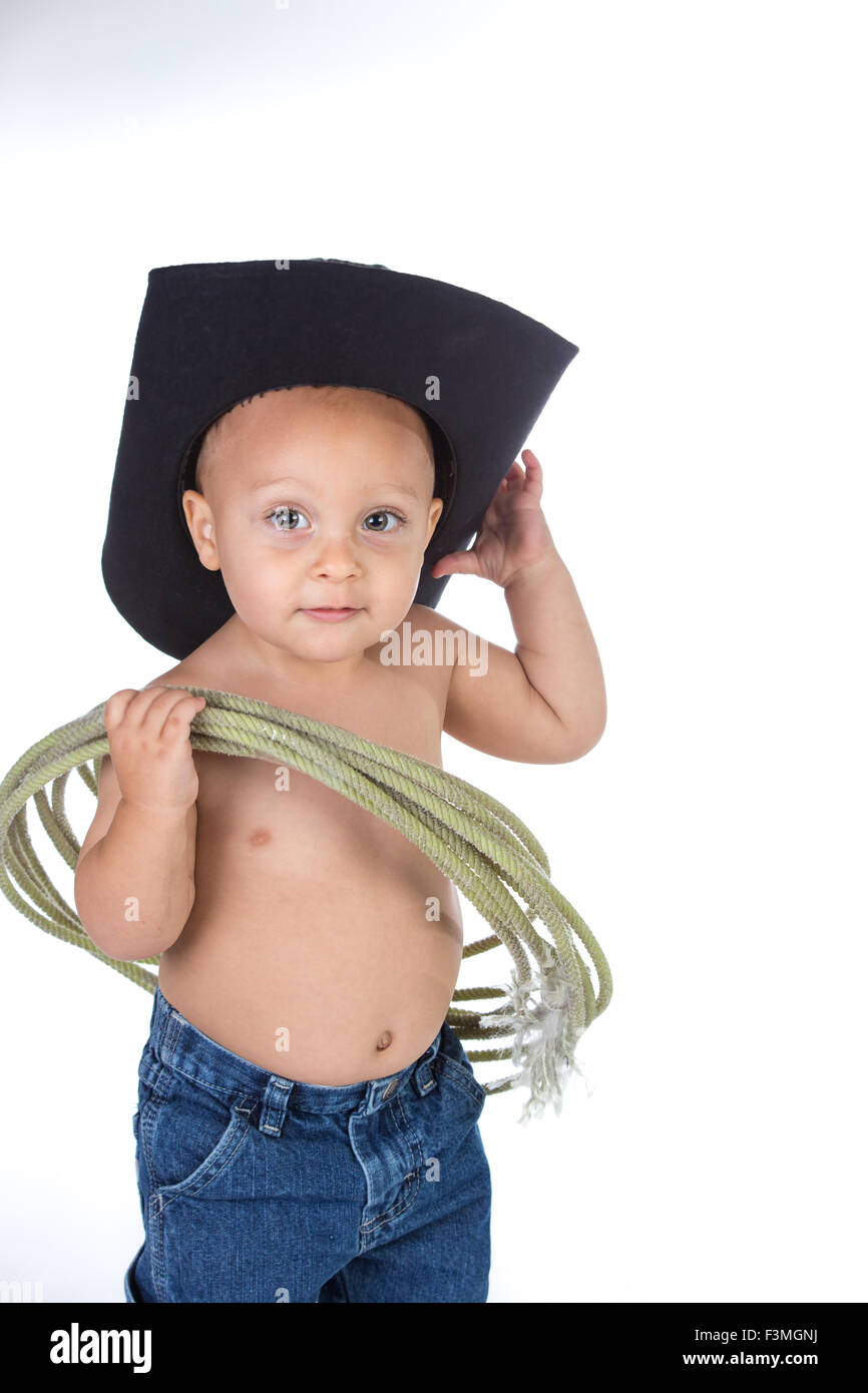 Baby boy dressed as cowboy posing in studio. Stock Photo