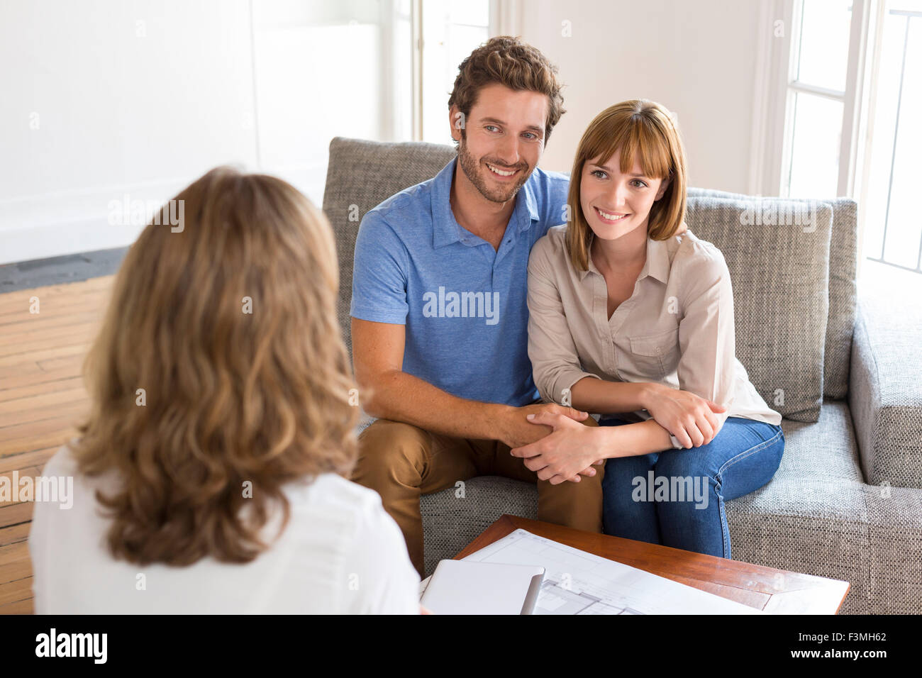 Thirty year old couple meeting with financial adviser for investment Stock Photo