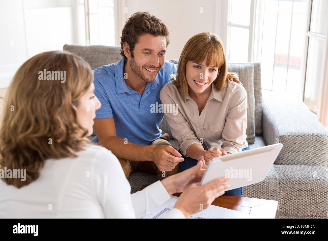 Real-estate agent presenting a new project property on digital tablet Stock Photo