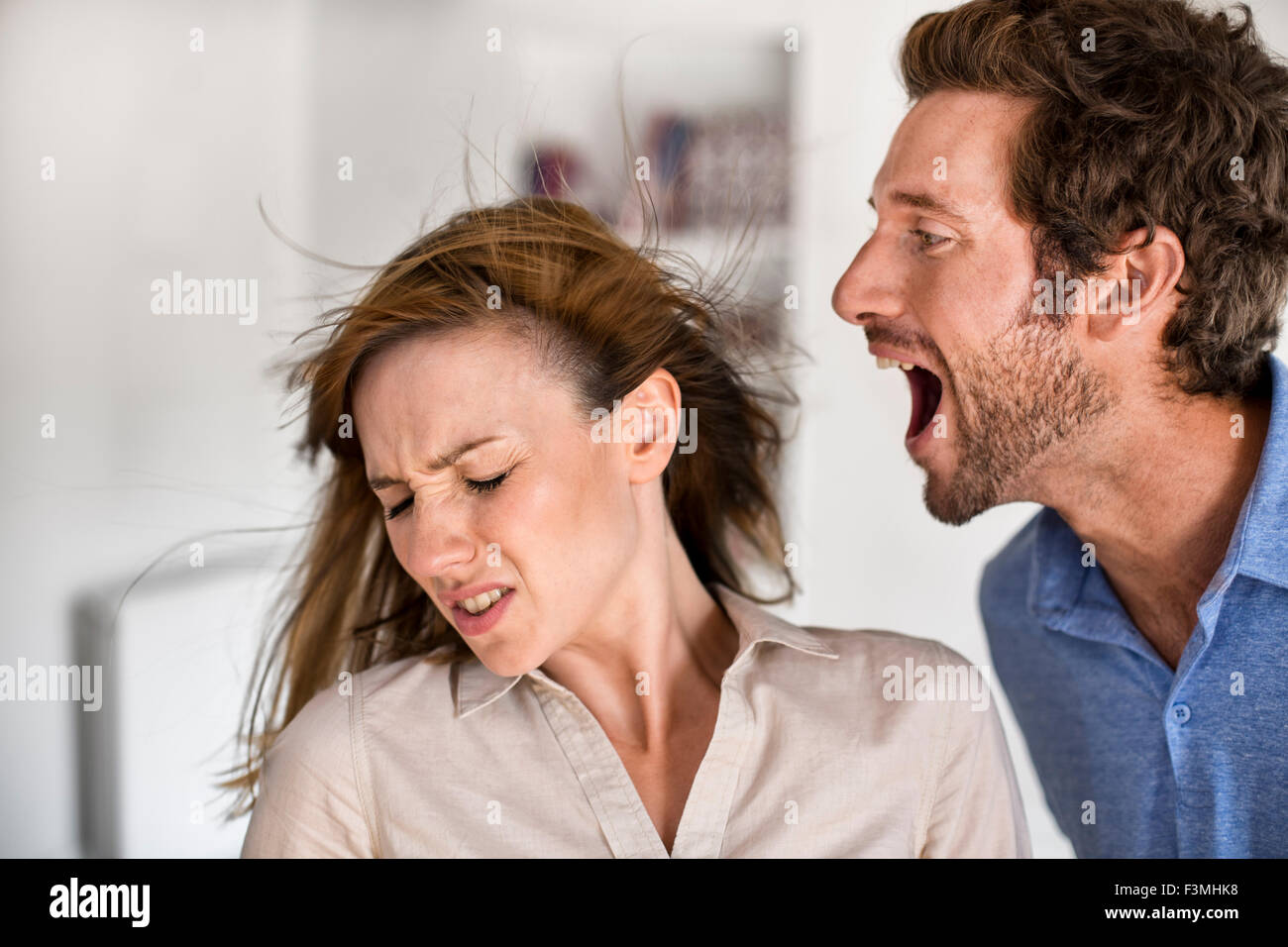 Angry man. He yells at his wife Stock Photo