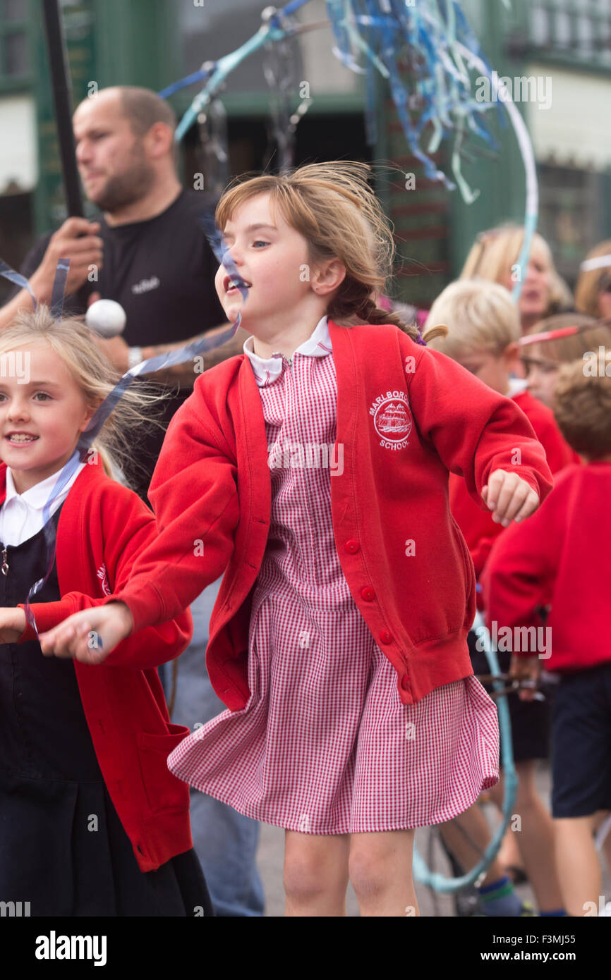 Falmouth, UK. Friday the 9th of October 2015. Girl from Malborough School leap in the air during the Falmouth Oyster Festival Parade through Arwenack Street in Falmouth. Credit:  Michael Hirst/Alamy Live News Stock Photo