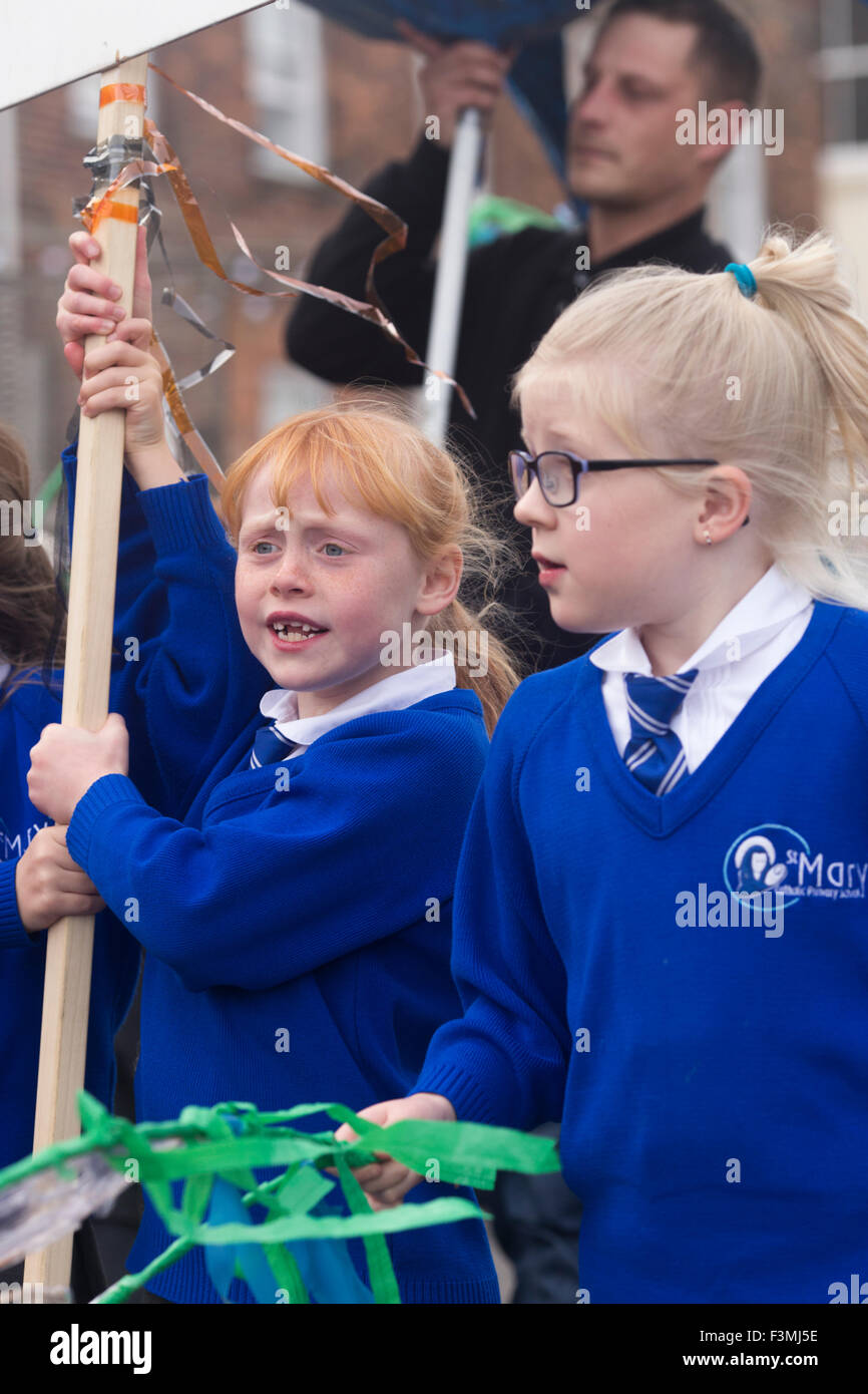 Falmouth, UK. Friday the 9th of October 2015. Girls from St Marys School in Falmouth carry the St Marys School banner as part of the Falmouth Oyster Festival 2015 through Arwenack Street in Falmouth. Credit:  Michael Hirst/Alamy Live News Stock Photo