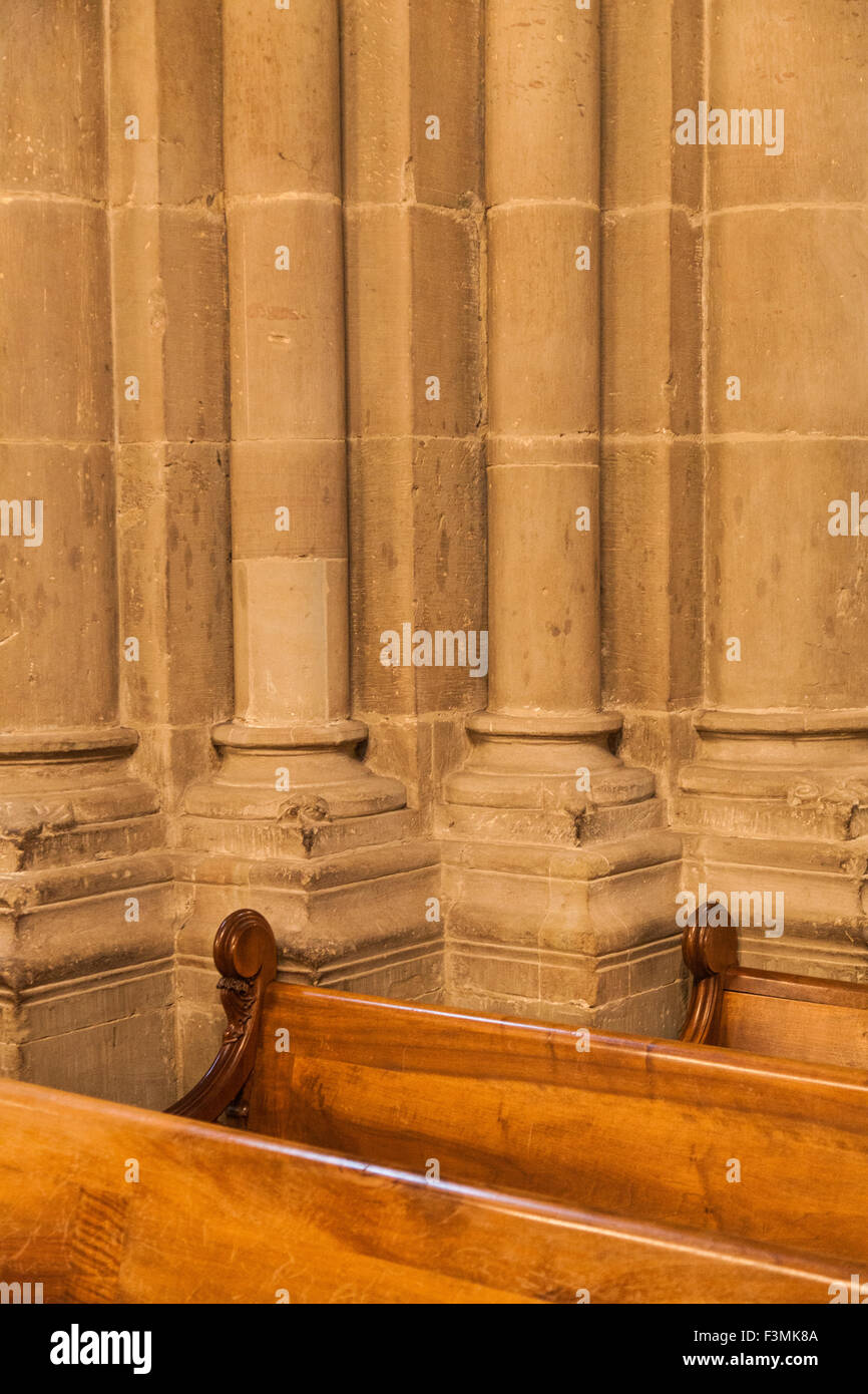 Abstract contrast between stone columns and wooden pews in Saint Peter's Cathedral, Geneva, Switzerland Stock Photo