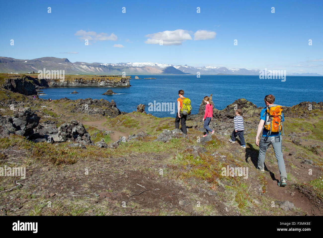 Family hiking the Hellnar-Arnarstapi coastal path, Snaefellsnes Peninsula, Vesturland, Iceland. Stock Photo
