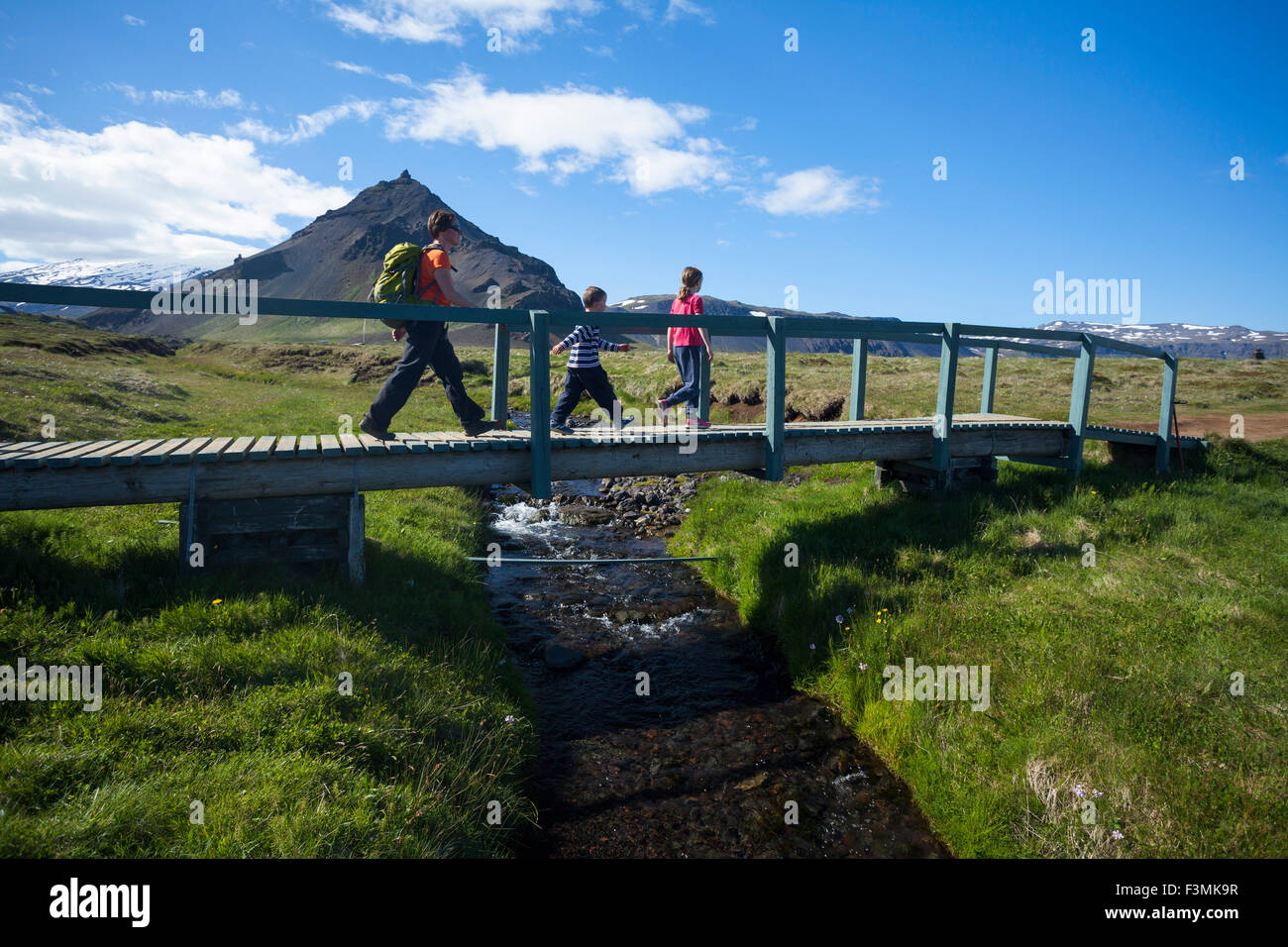 Family hiking the Hellnar-Arnarstapi coastal path, Snaefellsnes Peninsula, Vesturland, Iceland. Stock Photo