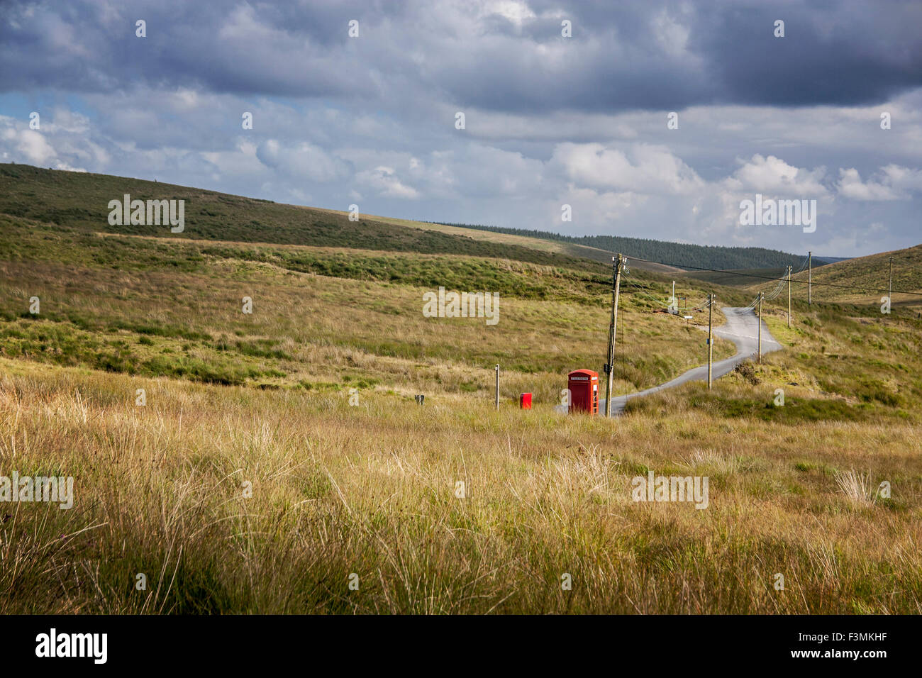 Remote traditional red K6 telephone box and post box by side of remote moorland road Near Abergwesyn Powys Mid Wales UK Stock Photo