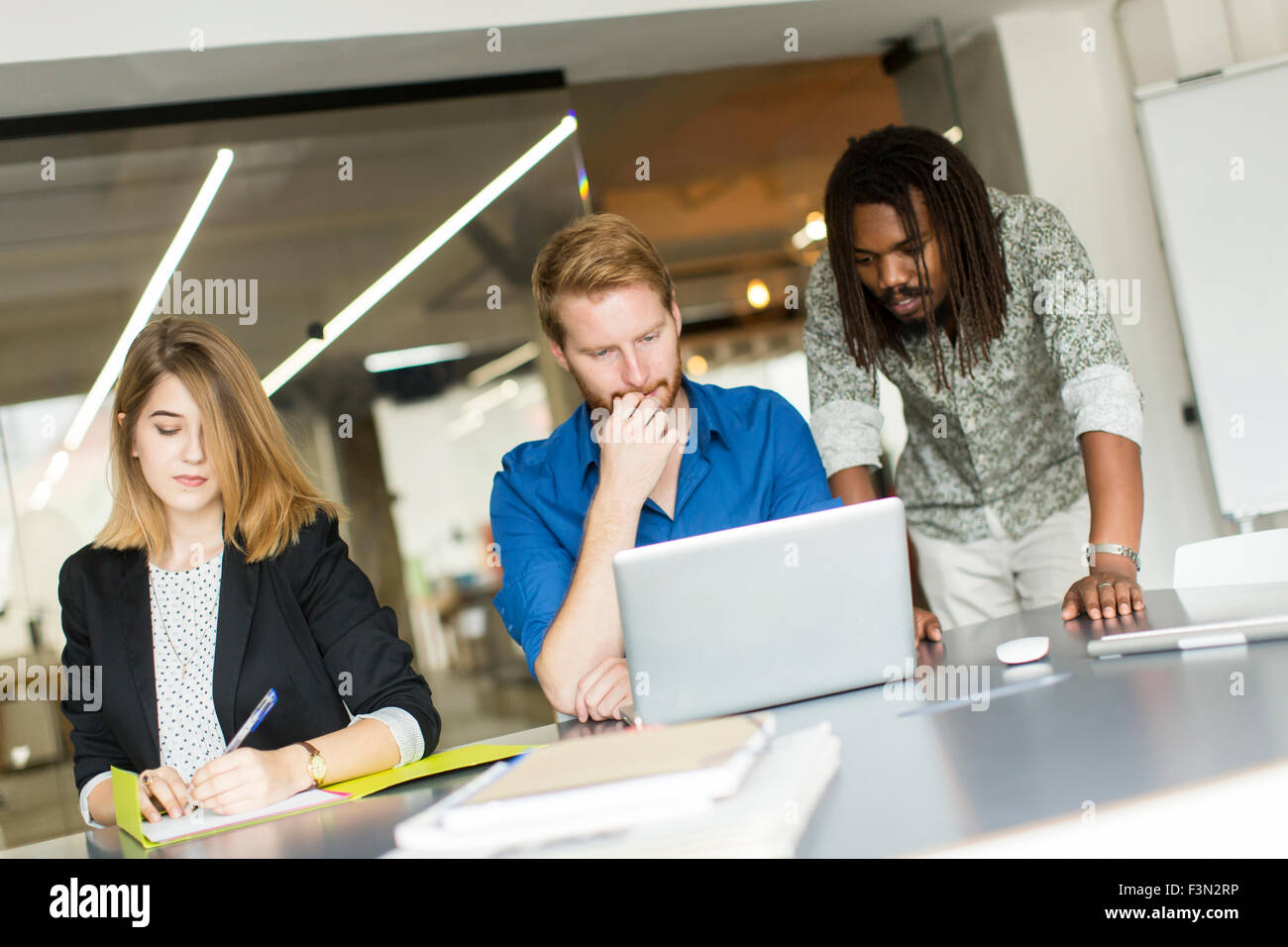 Young people in the office Stock Photo - Alamy