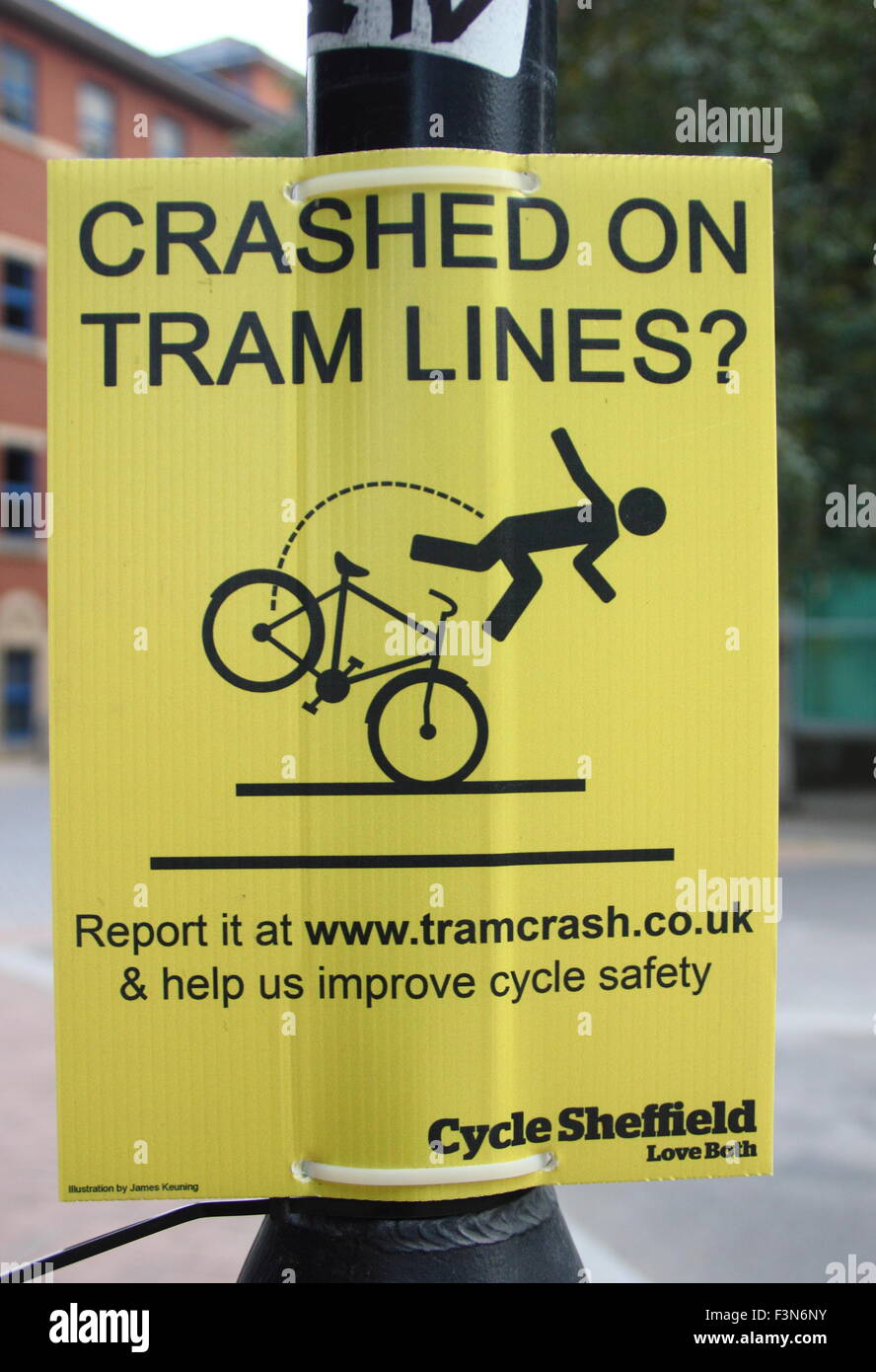A notice in Sheffield city centreencourages cyclists to report collisions with tramlines to www.tramcrash.co.uk - Yorkshire, UK Stock Photo