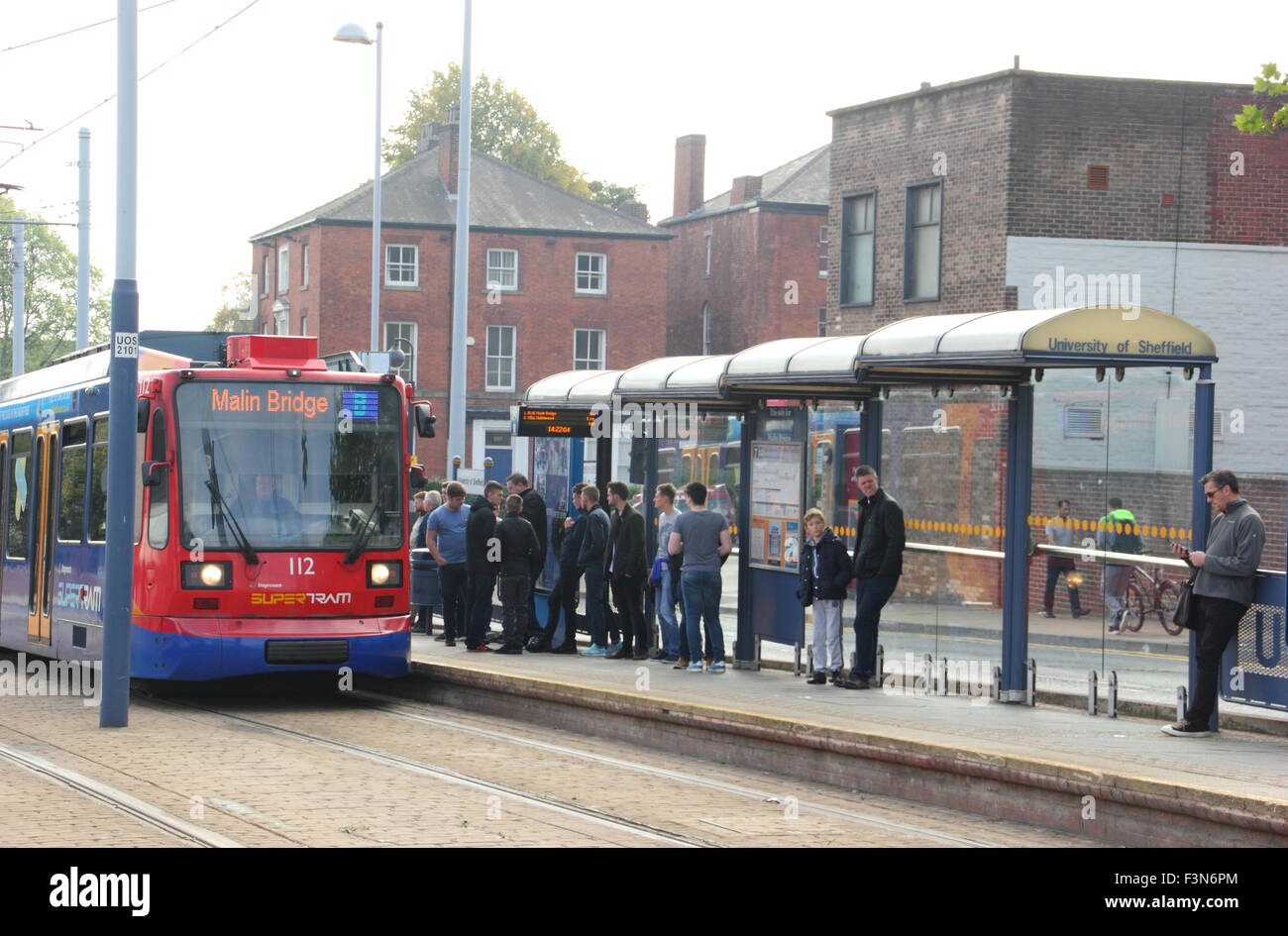 A Sheffield Stagecoach Supertram pauses at a stop on Upper Hanover Street in Sheffield city centre, South Yorkshire, England UK Stock Photo