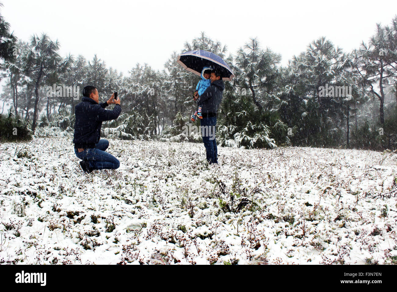 Bijie, China's Guizhou Province. 10th Oct, 2015. People pose for photos on a snow-covered grassland in Haila village, Weining county, southwest China's Guizhou Province, Oct. 10, 2015. The county witnessed a snowfall and a sudden drop in temperature on Saturday. Credit:  Wang Cheng/Xinhua/Alamy Live News Stock Photo