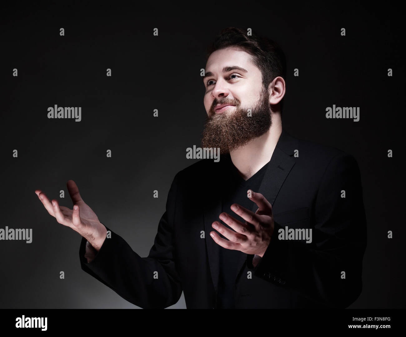 Portrait of a Teenage Hipster with Beard Gesticulating Stock Photo