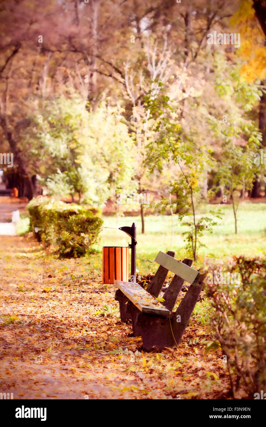Wooden bench in autumn park - vintage photo Stock Photo - Alamy