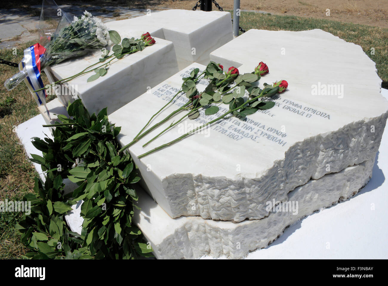 Russian naval battle memorial red roses and wreaths laid on its slab after the end of commemoration service. Lemnos, Greece Stock Photo