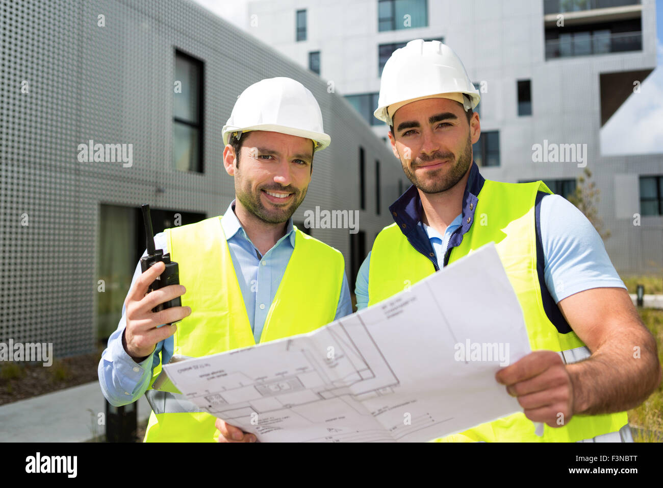 View of a Engineer and worker checking plan on construction site Stock ...
