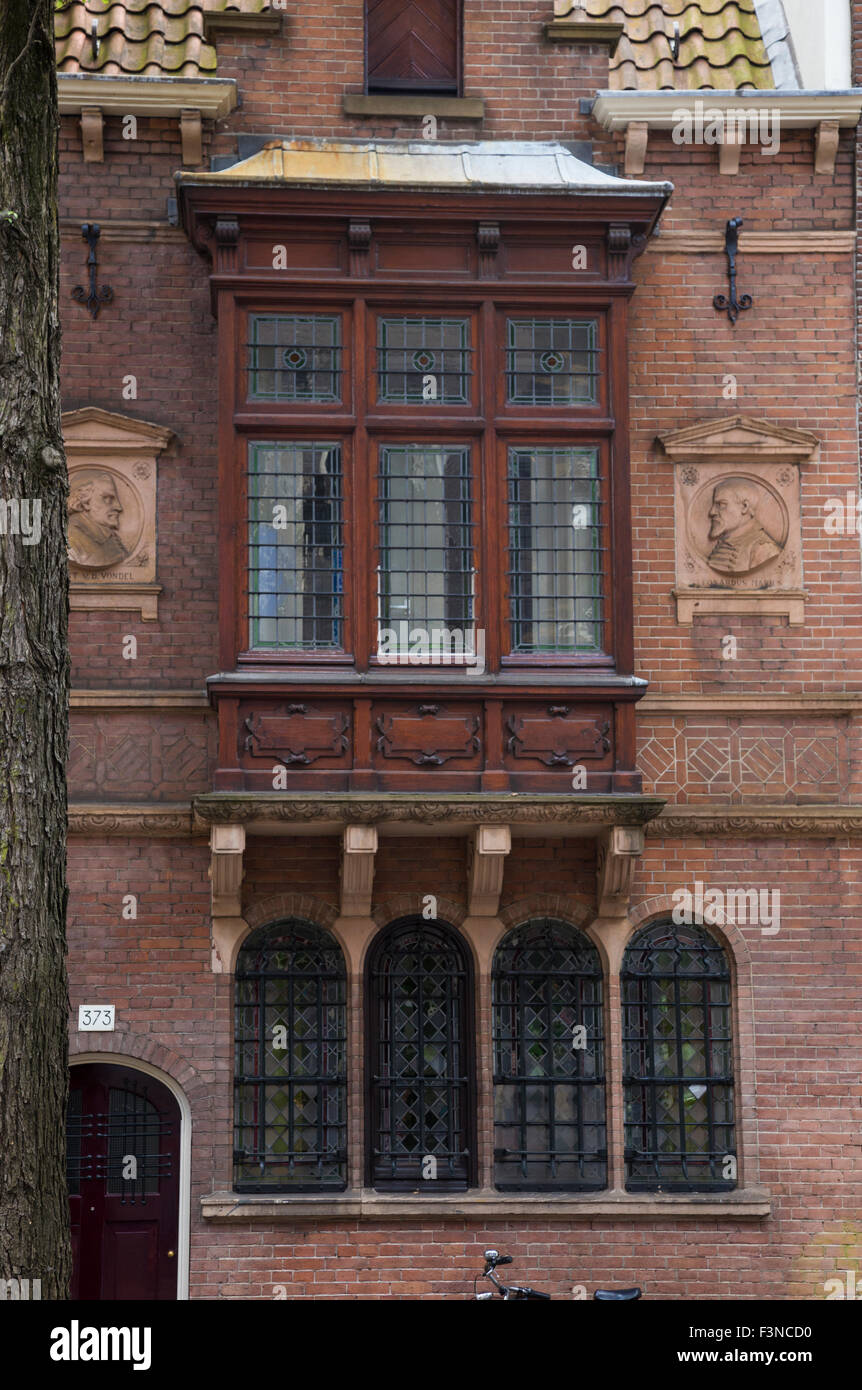 Old wood windows in Nieuwezijds Voorburgwal Amsterdam Stock Photo