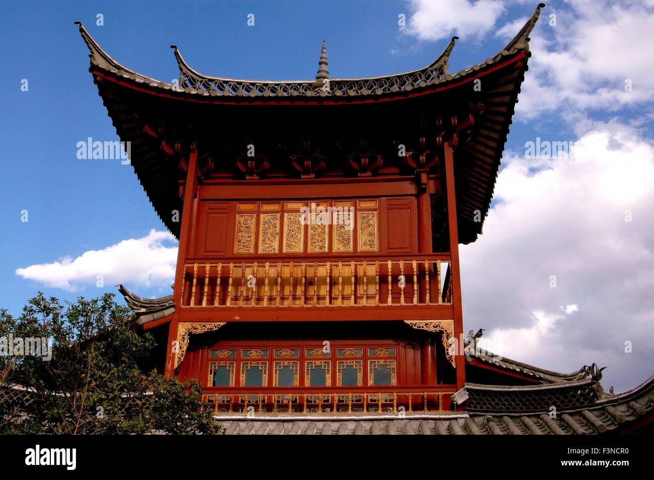 Lijiang, China:  Wooden tower house with upswept flying eave roofs on South Gate Square Stock Photo