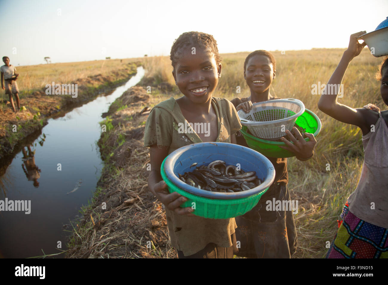 African girls fishing on the zambian flood plains Stock Photo