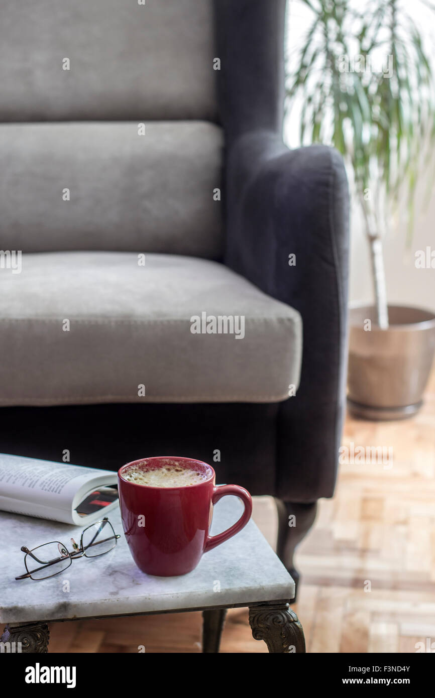 Interior design with armchair and marble table, close up Stock Photo