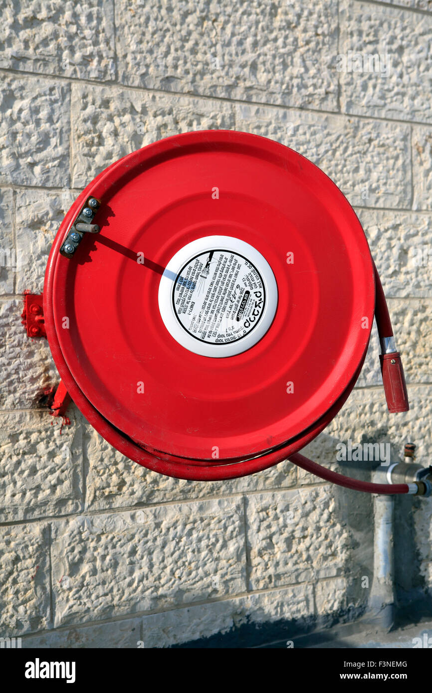 close up of fire hose reel at industrial building in Beit Shemesh, nearby Jerusalem, Israel Stock Photo