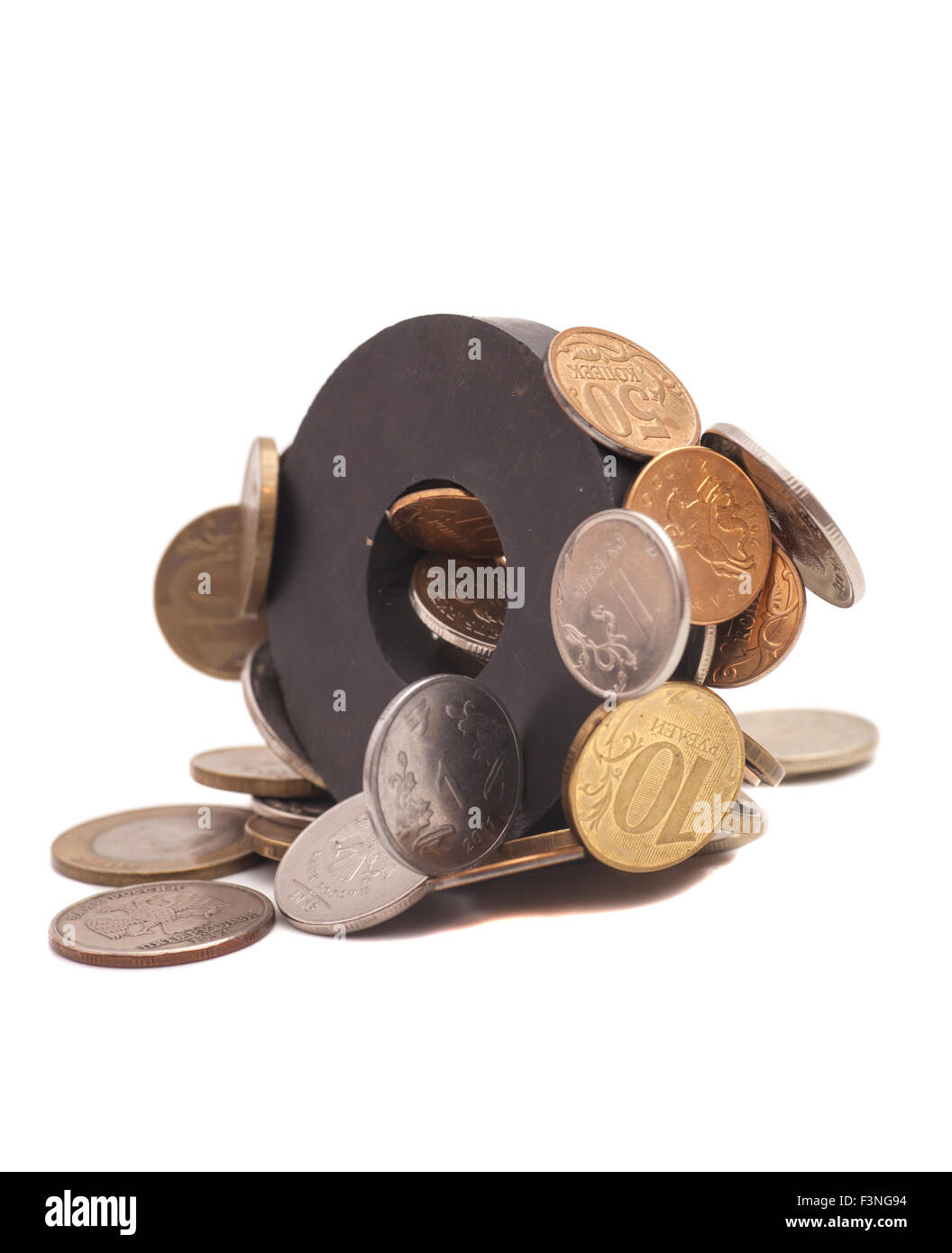 Coins attracted by magnet Stock Photo - Alamy