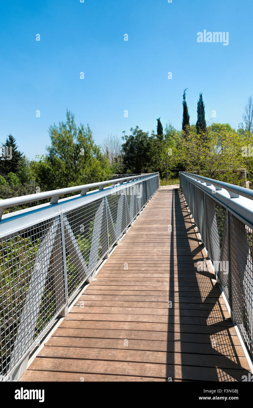 Beautiful metal bridge to the boardwalk over the creek in the park