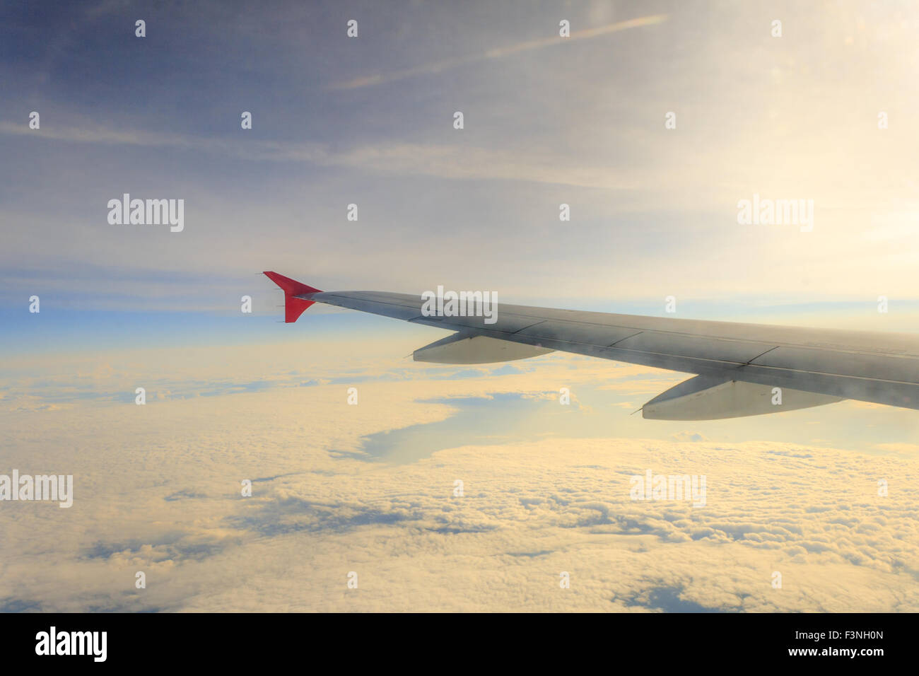 wing airplane high above the clouds Stock Photo - Alamy