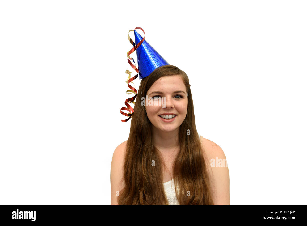 Girl wearing a blue party hat with red and gold streamers Stock Photo