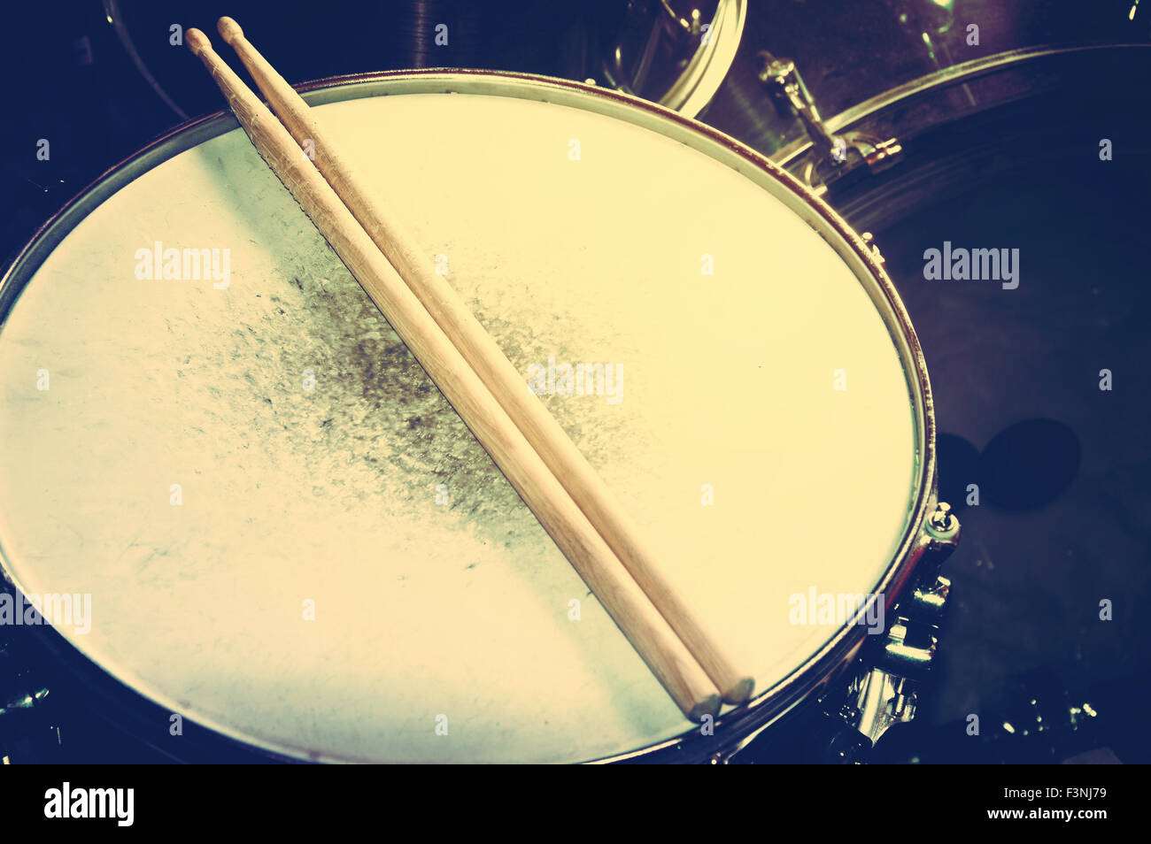 Drums conceptual image. Picture of drums and drumsticks lying on snare